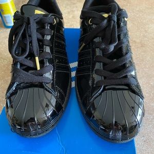 Black and gold Adidas Superstar Metal Toe